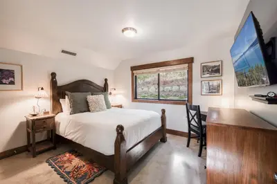 a bedroom with a bed and a desk and a window at Boathouse in the Woods by Tahoe Getaways - Minutes to Lake Tahoe & Northstar in Kings Beach