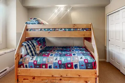 a bunk bed with a wooden frame in a bedroom at Mammoth Green - 207 in Mammoth Lakes