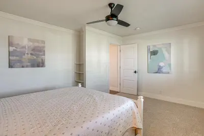 a bedroom with a bed and a ceiling fan at 5 Min to Fast Water Waterfront Discovery Bay Home in Discovery Bay