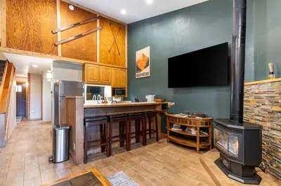 a kitchen with a fireplace and a stove at Northstar Resort 2BR Condo with Rec Center Access in Truckee