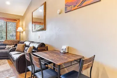 a living room with a table and a couch at Northstar Resort 2BR Condo with Rec Center Access in Truckee