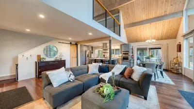 a living room with a couch and a table at Retreat with Lake Access Deck Modern Interior Agate Peak by Avantstay in Carnelian Bay