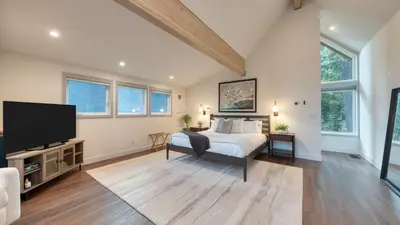 a bedroom with a bed and a flat screen tv at Retreat with Lake Access Deck Modern Interior Agate Peak by Avantstay in Carnelian Bay