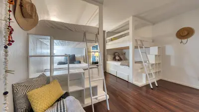 a room with two bunk beds and a ladder at Retreat with Lake Access Deck Modern Interior Agate Peak by Avantstay in Carnelian Bay