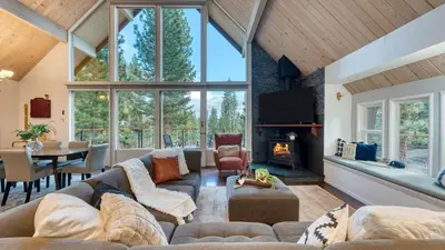 a living room with a couch and a fireplace at Retreat with Lake Access Deck Modern Interior Agate Peak by Avantstay in Carnelian Bay