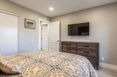 a bedroom with a bed and a flat screen tv at Snowcreek IV 559 in Mammoth Lakes