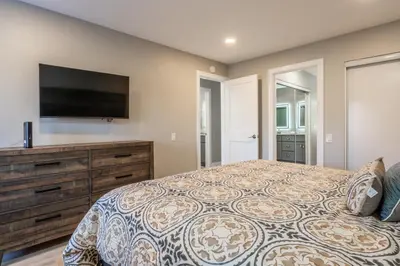 a bedroom with a bed and a flat screen tv at Snowcreek IV 559 in Mammoth Lakes
