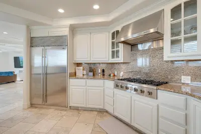 a kitchen with white cabinets and a stainless steel refrigerator at Luxury Pilot Hill Estate on an 800-Acre Vineyard in Pilot Hill