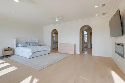 a white bedroom with a bed and a flat screen tv at Luxury Pilot Hill Estate on an 800-Acre Vineyard in Pilot Hill