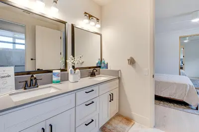 a bathroom with two sinks and a large mirror at Luxury Pilot Hill Estate on an 800-Acre Vineyard in Pilot Hill