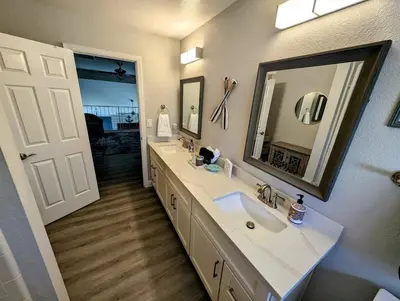 a bathroom with two sinks and a large mirror at 3 Bedrooms - Game Room - On the water in Discovery Bay