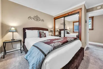 a bedroom with a large bed and a mirror at South Lake Retreat Deck Dock & Game Table in South Lake Tahoe