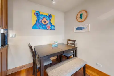 a dining room table with chairs and a painting on the wall at Aspen Edge Lakefront and Loft in South Lake Tahoe