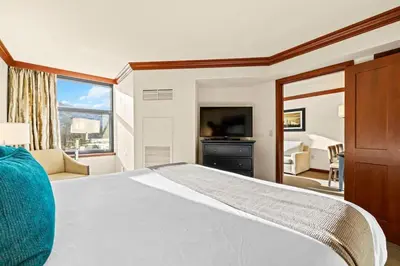 a bedroom with a large bed and a television at 6th Floor Fireplace Suite in Tahoe City