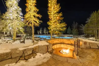 a fire pit in a snow covered yard at night at 6th Floor Fireplace Suite in Tahoe City