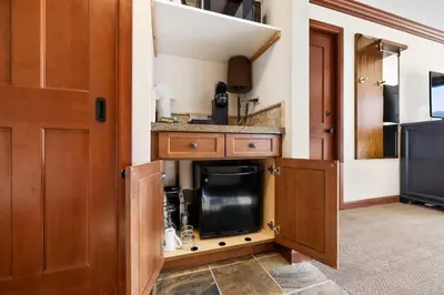 a kitchen with wooden cabinets and a counter top at Studio Suite 2 Queen Beds Mountain View in Tahoe City