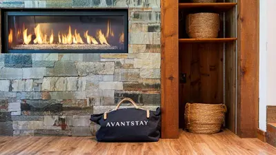 a fireplace with a tv on a stone wall at Cozy Tahoe Townhome w Fireplace Balcony Quick Access to Trails Lake Cubana - Dollar Hill by AvantStay in Tahoe City