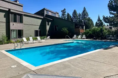 a swimming pool in front of a house at Summit 65 in Mammoth Lakes