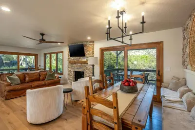 a living room with a dining table and a fireplace at Prime Sequoia Stay Pool Hot Tub Sauna Views in Three Rivers