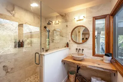a bathroom with a tub and a sink and a mirror at Prime Sequoia Stay Pool Hot Tub Sauna Views in Three Rivers