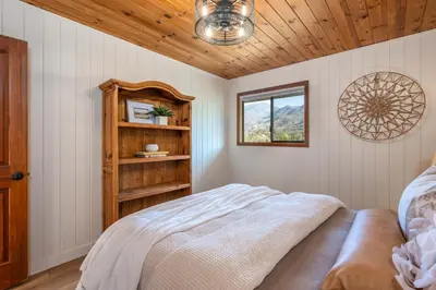 a bedroom with a bed and a wooden ceiling at Prime Sequoia Stay Pool Hot Tub Sauna Views in Three Rivers
