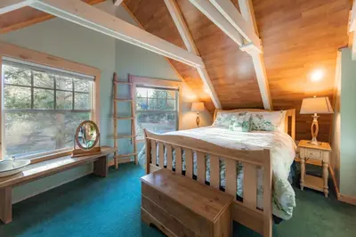 a bedroom with a bed and a wooden ceiling at The Ale Arths Retreat for 8 in South Lake Tahoe