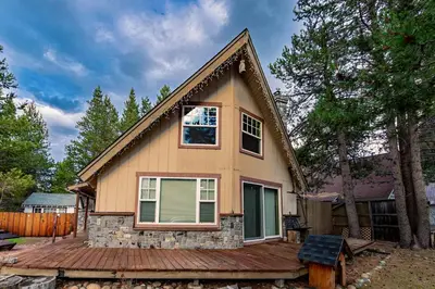 a small house on a wooden deck in a yard at The Ale Arths Retreat for 8 in South Lake Tahoe