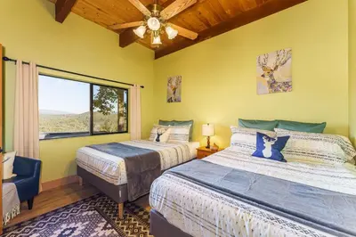 a bedroom with two beds and a window at Yosemite Lodge 5BR Villa Hot Tub Game Room EV in Oakhurst