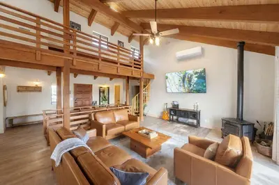 a living room with leather furniture and a fireplace at Yosemite Lodge 5BR Villa Hot Tub Game Room EV in Oakhurst