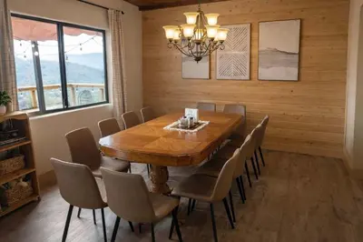 a dining room with a wooden table and chairs at Yosemite Lodge 5BR Villa Hot Tub Game Room EV in Oakhurst
