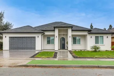 a large white house with a garage at Sip, Dine and Unwind Spacious Lodi Gem with Patio! in Lodi