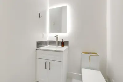 a white bathroom with a sink and a toilet at Sip, Dine and Unwind Spacious Lodi Gem with Patio! in Lodi