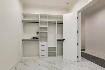a white walk in closet with white cabinets at Sip, Dine and Unwind Spacious Lodi Gem with Patio! in Lodi