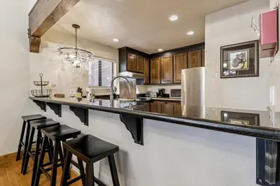 a kitchen with a counter and bar stools in it at 1192 Timber Lane home in South Lake Tahoe
