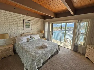 a bedroom with a bed and a view of the water at 439 Ala Wai, 119 condo in South Lake Tahoe