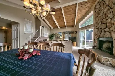 a dining room with a table and a fireplace at 1673 Venice Drive home in South Lake Tahoe