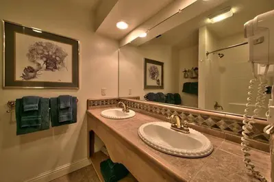 a bathroom with two sinks and a large mirror at 1673 Venice Drive home in South Lake Tahoe