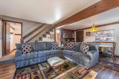 a living room with a blue couch and a table at Fred's Retreat cabin in Homewood