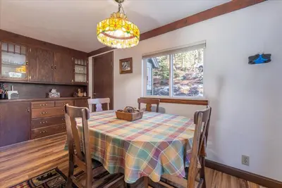 a kitchen and dining room with a table and a window at Fred's Retreat cabin in Homewood