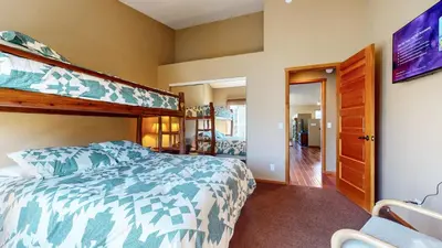 a bedroom with a bunk bed and a chair at Snowcreek V #1002 condo in Mammoth Lakes