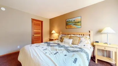 a bedroom with a bed and a desk with a lamp at Snowcreek V #1002 condo in Mammoth Lakes