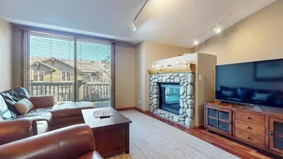 a living room with a couch and a fireplace at Snowcreek V #1002 condo in Mammoth Lakes