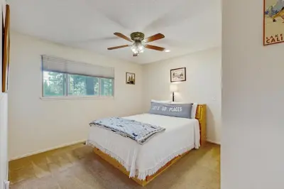 a bedroom with a bed and a ceiling fan at Mid-Century Tahoe Ranch House in South Lake Tahoe