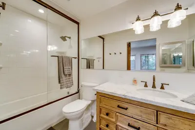 a white bathroom with a toilet and a sink at All-Season Fun! Family Tahoe North Shore Getaway in Incline Village