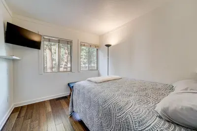 a bedroom with a bed and two windows at All-Season Fun! Family Tahoe North Shore Getaway in Incline Village