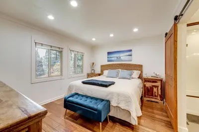 a bedroom with a king sized bed and windows at All-Season Fun! Family Tahoe North Shore Getaway in Incline Village