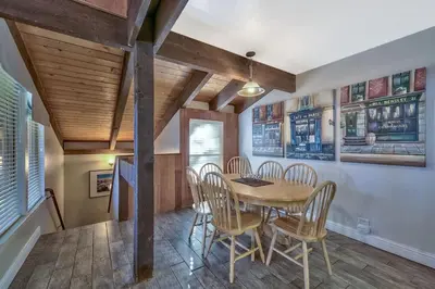 a dining room with a wooden table and chairs at Lakefront Townhome in South Lake Tahoe in South Lake Tahoe