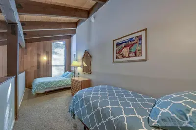 a bedroom with two beds and a window at Lakefront Townhome in South Lake Tahoe in South Lake Tahoe