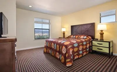 a hotel room with a bed and a television at Wyndham Angels Camp- 1 BR- Apartment with Resort Access in Angels Camp