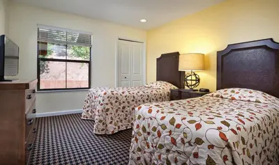 a hotel room with two beds and a window at Wyndham Angels Camp- 1 BR- Apartment with Resort Access in Angels Camp